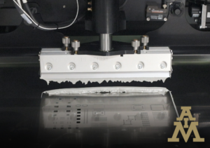 Solder paste being applied via squeegee